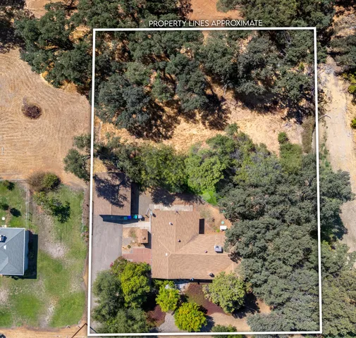 an aerial view of a house with a yard