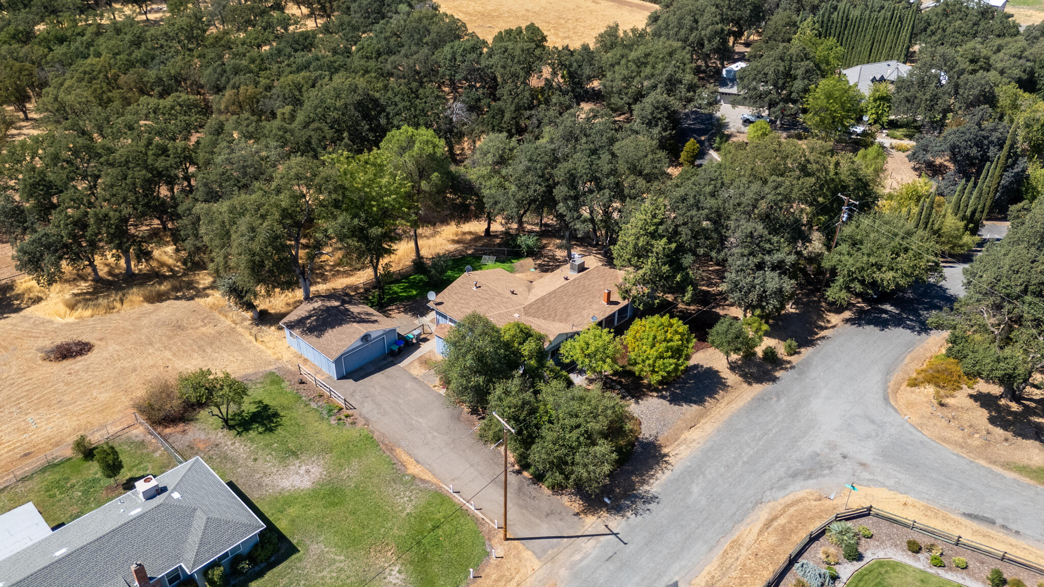 14575 Kinney Avenue Red Bluff, CA 96080 - Photo 38 of 43 an aerial view of a house with a yard and mountain view in back