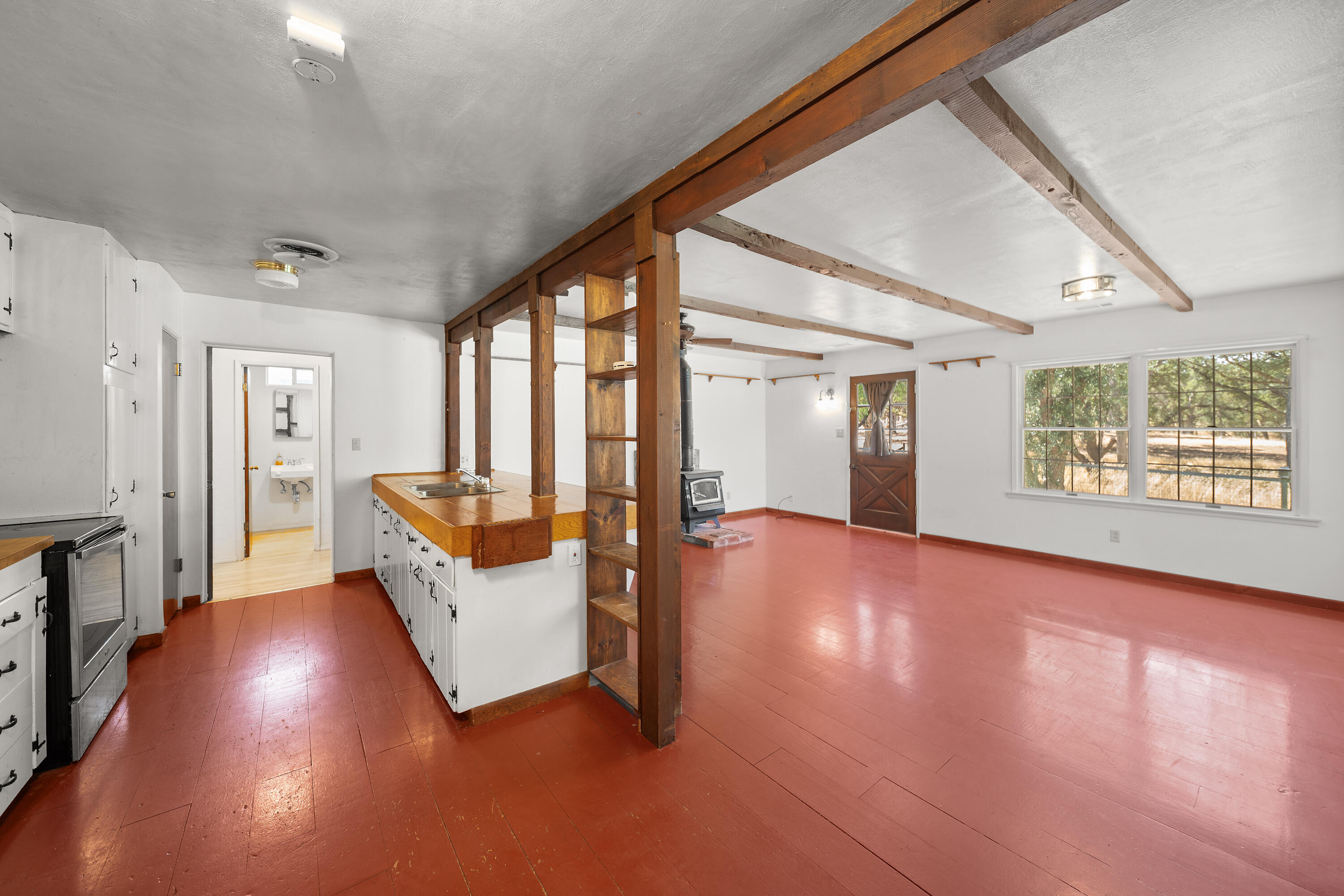 14575 Kinney Avenue Red Bluff, CA 96080 - Photo 8 of 43 a view of a big room with wooden floor and windows