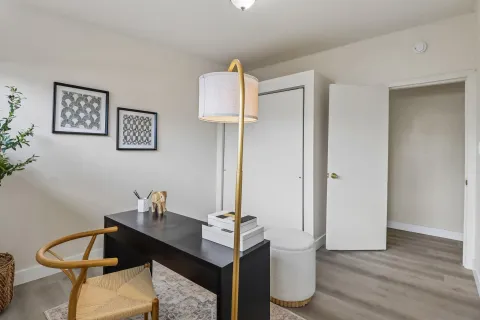 a view of a room with a table and chairs