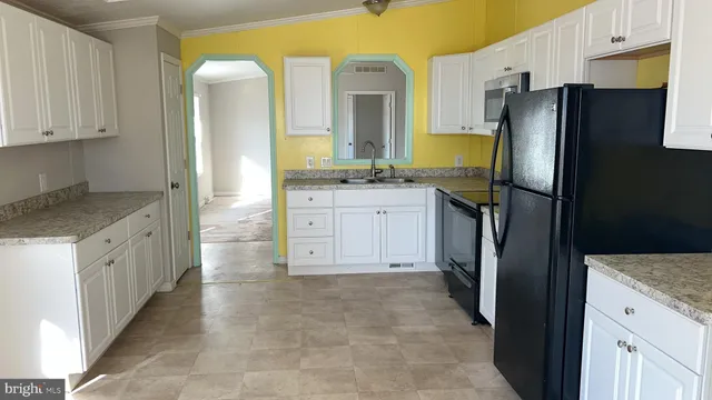 a kitchen with stainless steel appliances granite countertop a refrigerator and a stove