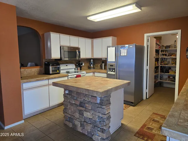 a kitchen with cabinets and center island