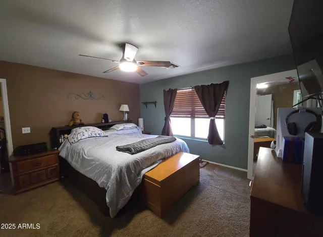 a bedroom with bed and window