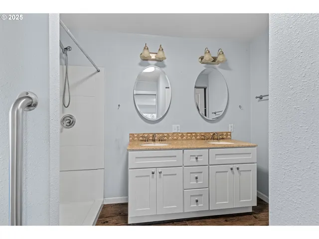 a bathroom with a sink a mirror and a light fixture