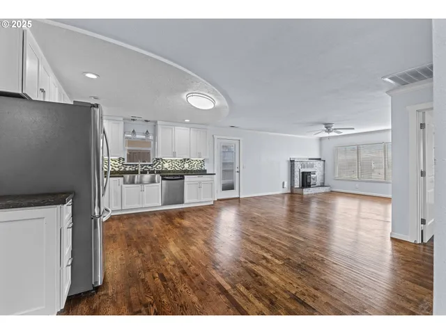 a view of a kitchen with a sink and a refrigerator