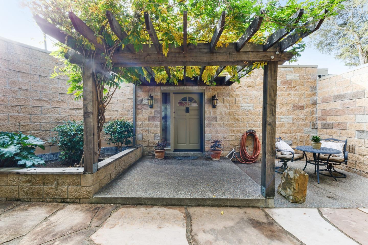 13456 Indian Trail Road Los Gatos, CA 95033 - Photo 13 of 99 a view of a patio with table and chairs potted plants and a large tree
