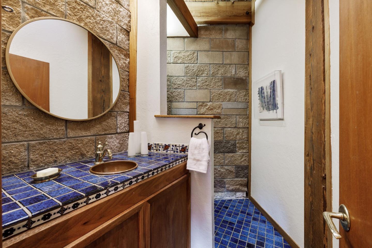 13456 Indian Trail Road Los Gatos, CA 95033 - Photo 23 of 99 a bathroom with a granite countertop sink a mirror and vanity