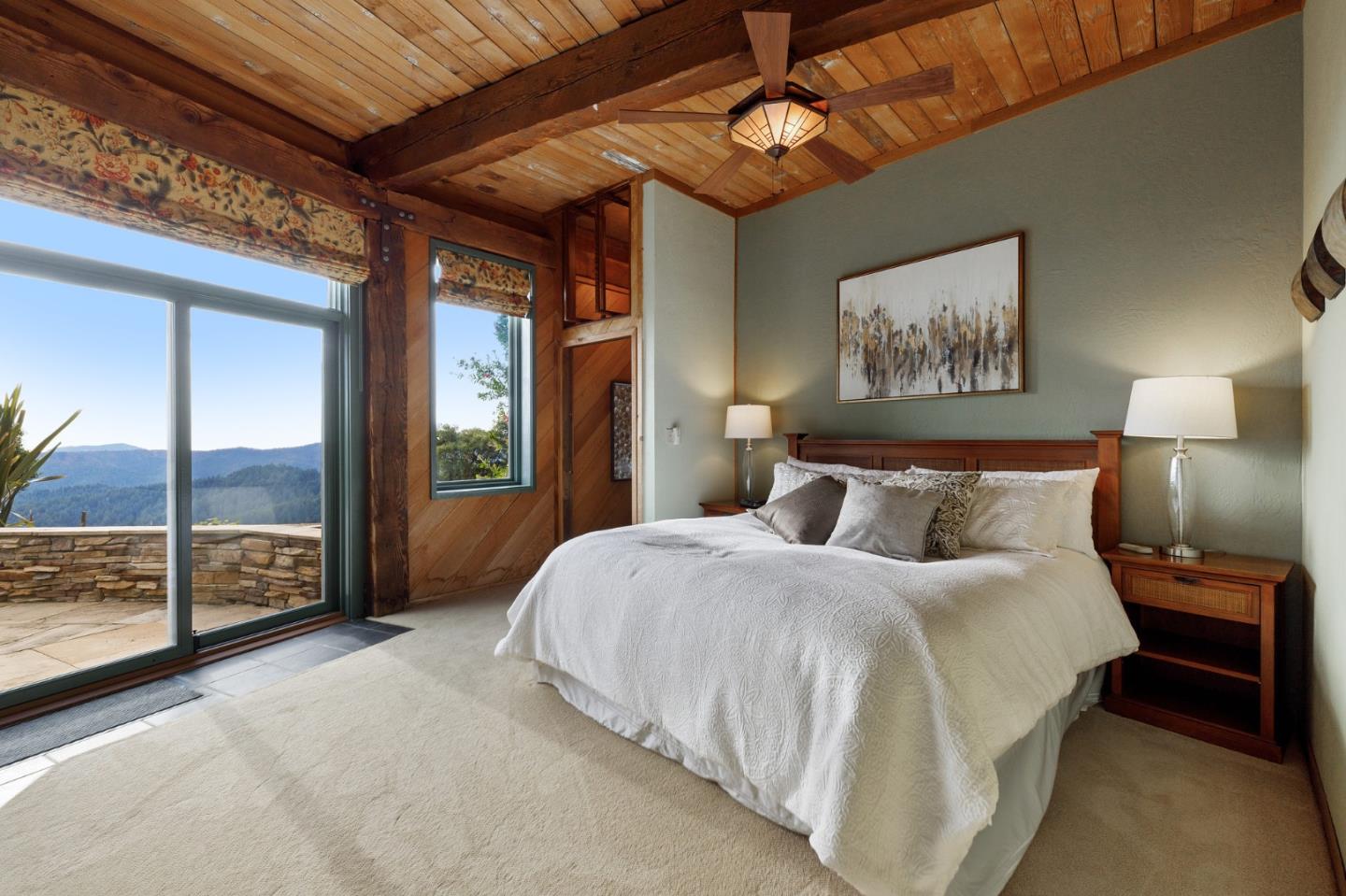 13456 Indian Trail Road Los Gatos, CA 95033 - Photo 38 of 99 a spacious bedroom with a large bed and a chandelier