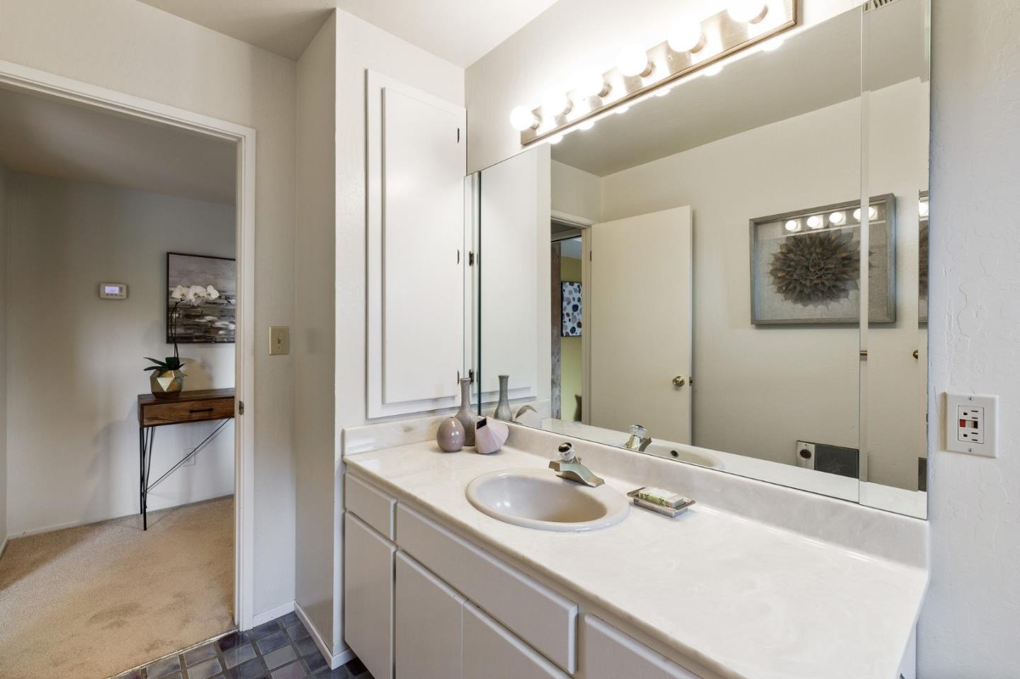 13456 Indian Trail Road Los Gatos, CA 95033 - Photo 58 of 99 a en suite bathroom with a sink and a mirror