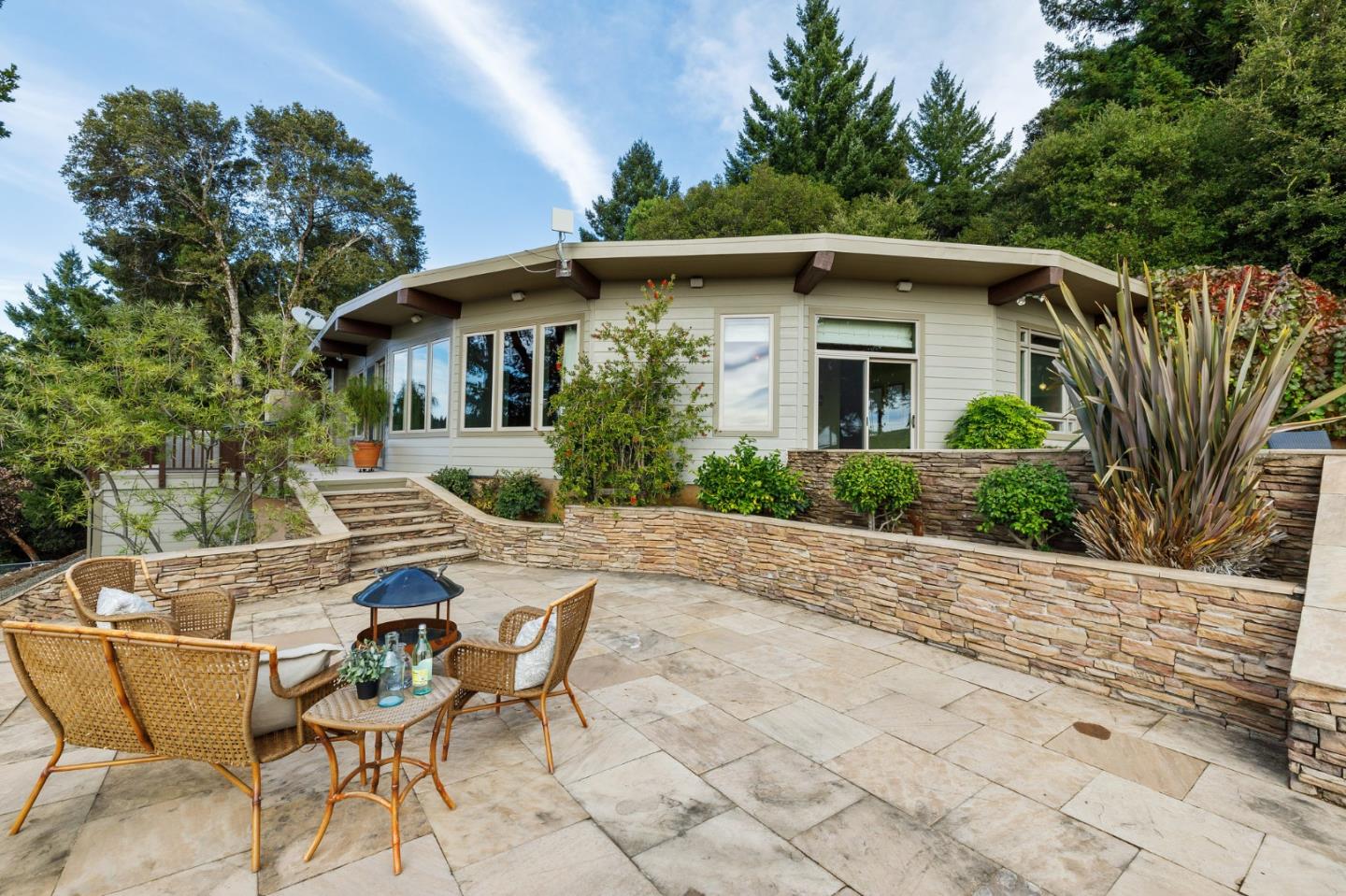 13456 Indian Trail Road Los Gatos, CA 95033 - Photo 64 of 99 a view of a wooden chairs and table in the patio in front of the house