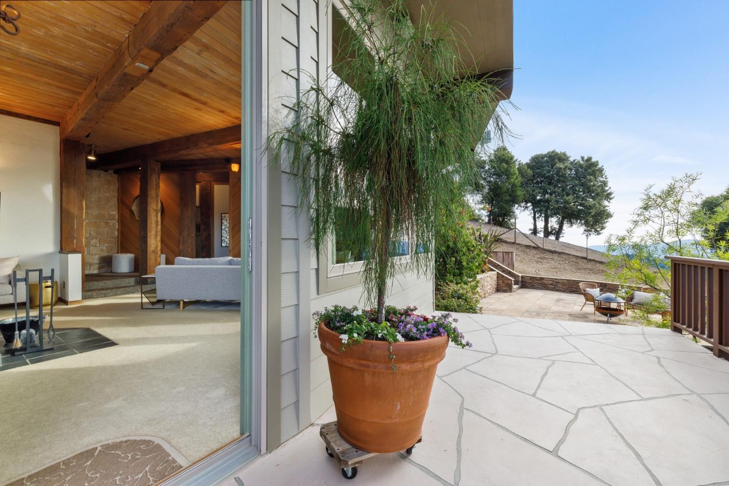 13456 Indian Trail Road Los Gatos, CA 95033 - Photo 69 of 99 a view of a patio with plants and table and chairs under an umbrella