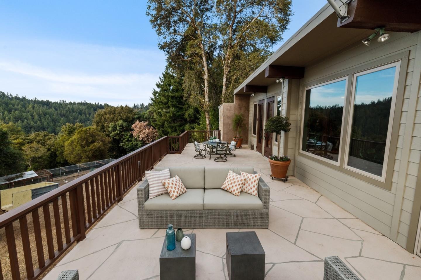 13456 Indian Trail Road Los Gatos, CA 95033 - Photo 75 of 99 a view of a patio with couches table and chairs and potted plants