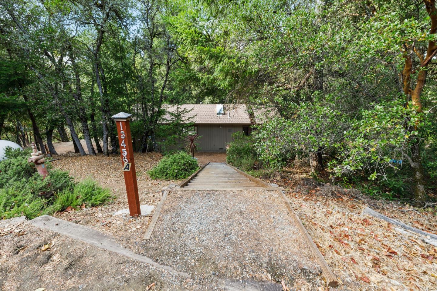 13456 Indian Trail Road Los Gatos, CA 95033 - Photo 82 of 99 a pathway of a house with a yard and large trees