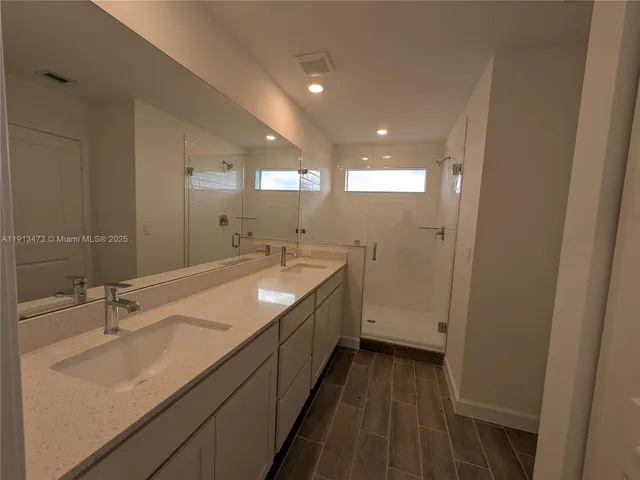a bathroom with a double vanity sink and a mirror