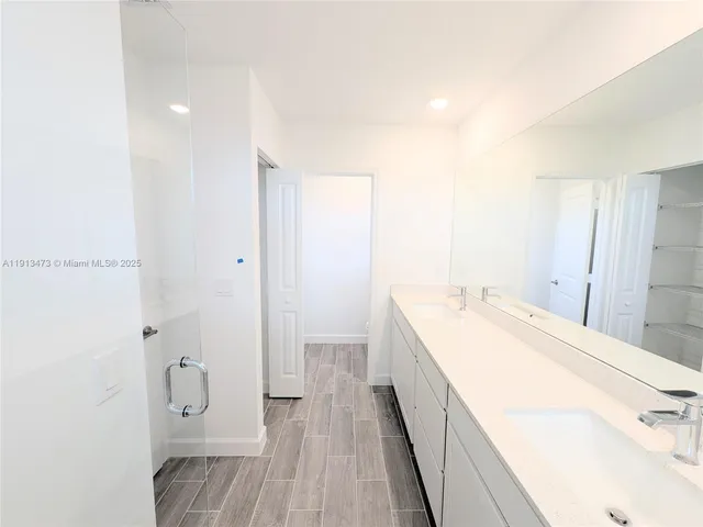 a spacious bathroom with a granite countertop sink a toilet and shower