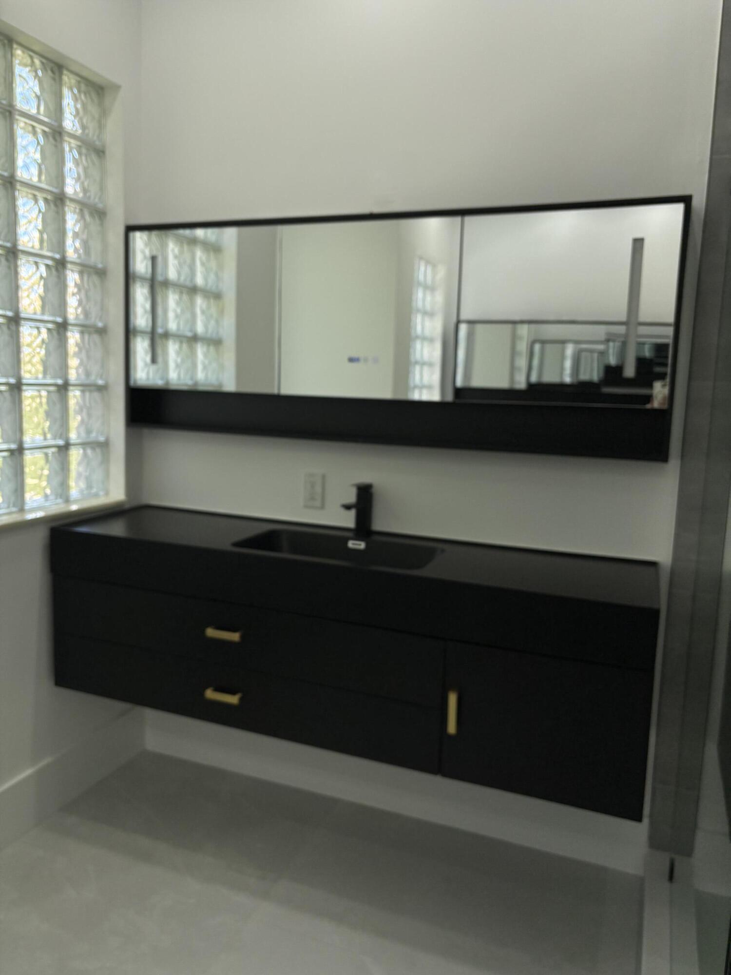 5227 Southwest 195th Terrace Miramar, FL 33029 - Photo 41 of 58 a bathroom with a sink and a mirror