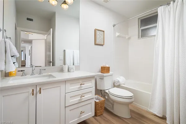 a bathroom with a toilet a sink and a mirror