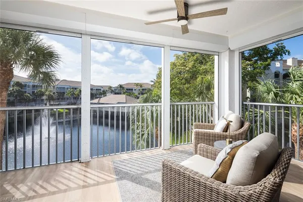 a balcony view with a couch and wooden floor