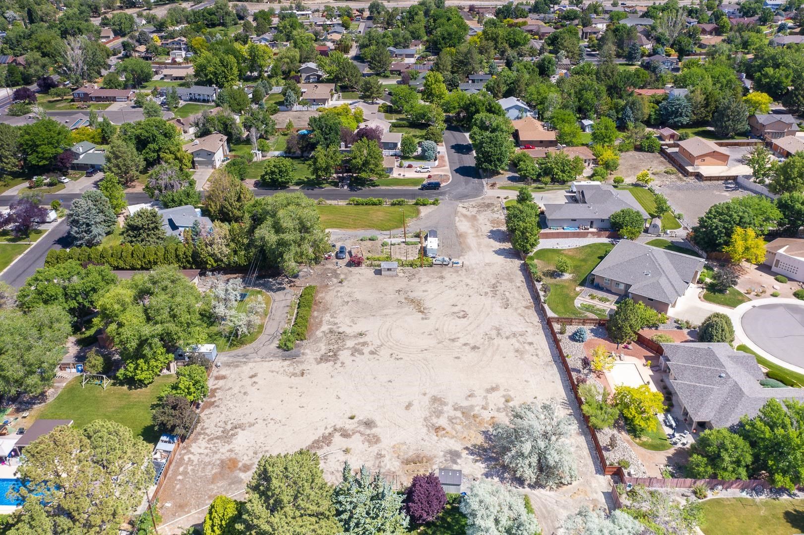 2663 G 3/8 Road Grand Junction, CO 81506 - Photo 5 of 6 an aerial view of a swimming pool with lawn chairs and large trees