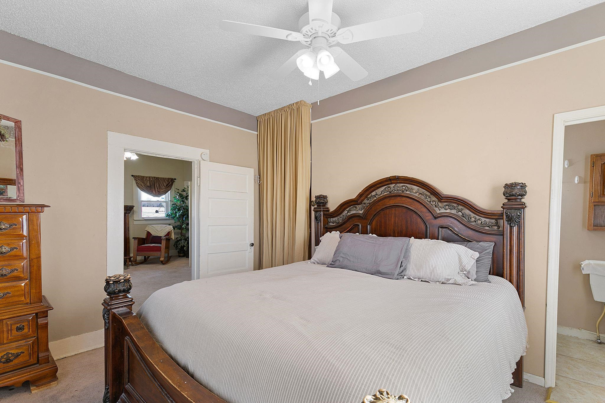 5118 Old Jackson Road Bells, TN 38006 - Photo 13 of 21 a bedroom with a bed and a chandelier