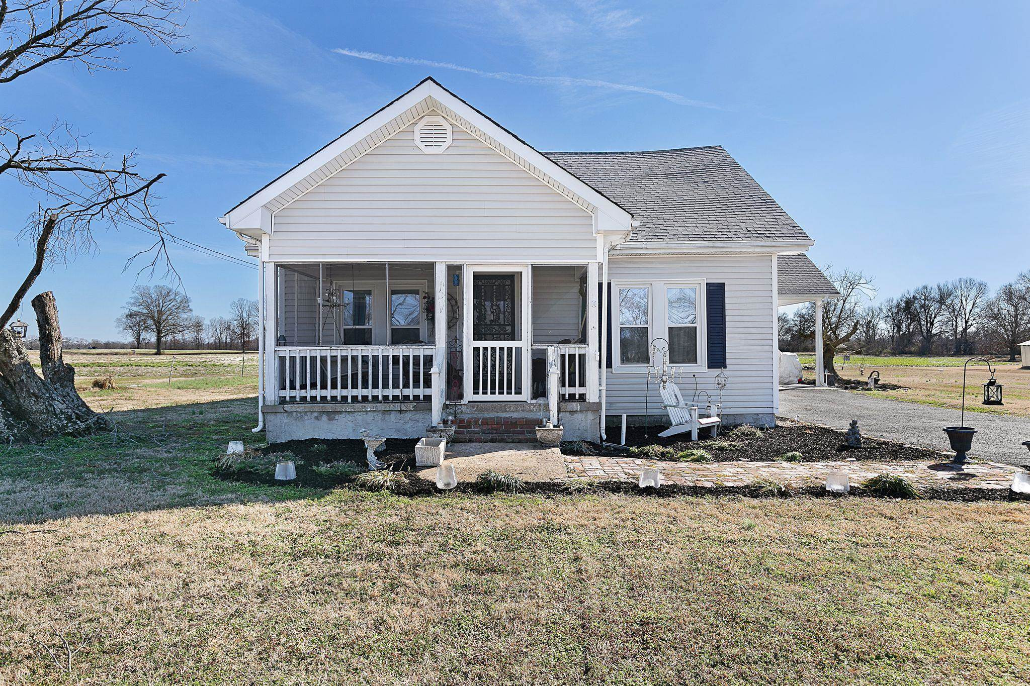 5118 Old Jackson Road Bells, TN 38006 - Photo 2 of 21 a backyard of a house with barbeque oven table and chairs