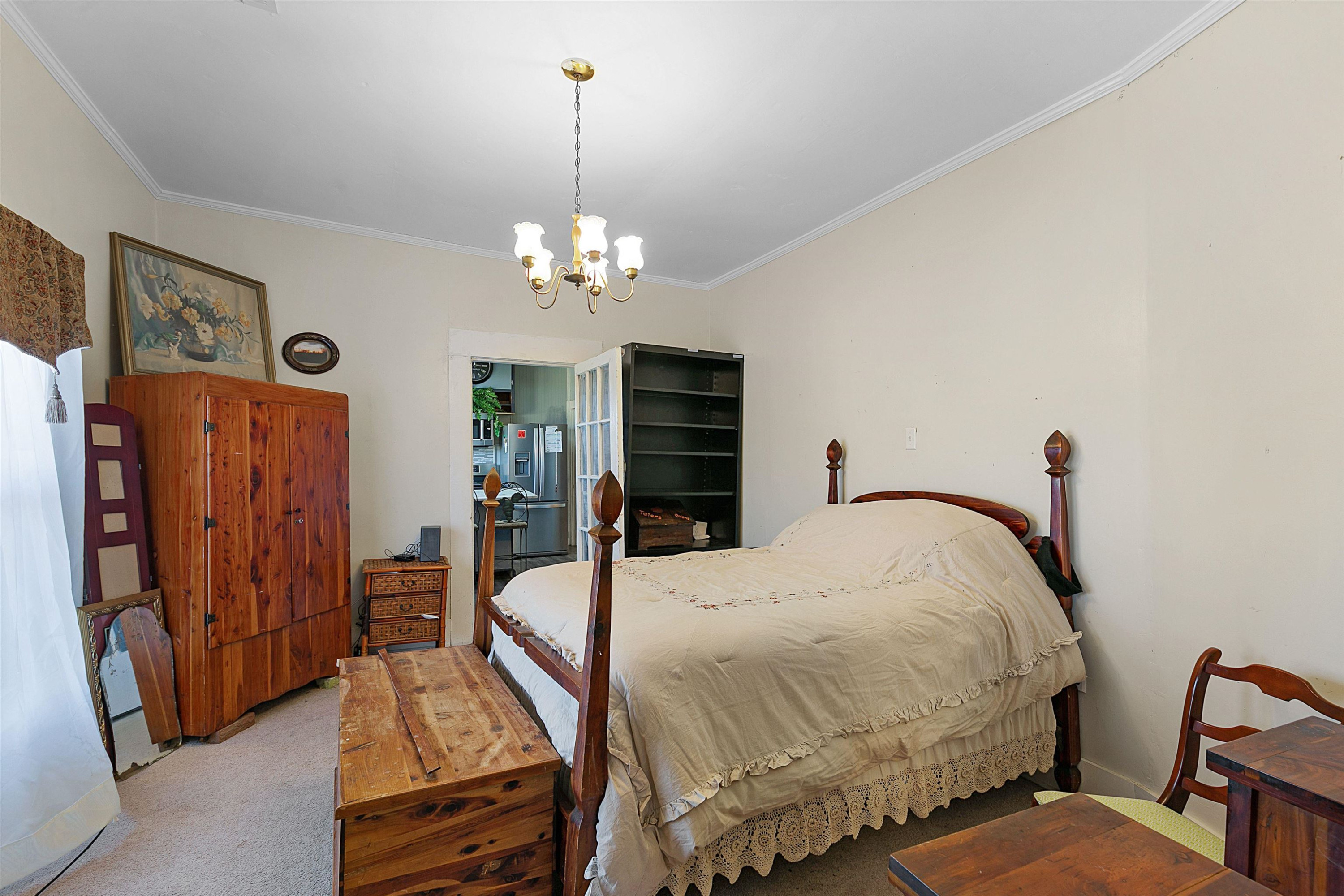 5118 Old Jackson Road Bells, TN 38006 - Photo 10 of 21 a bed room with a bed and a chandelier