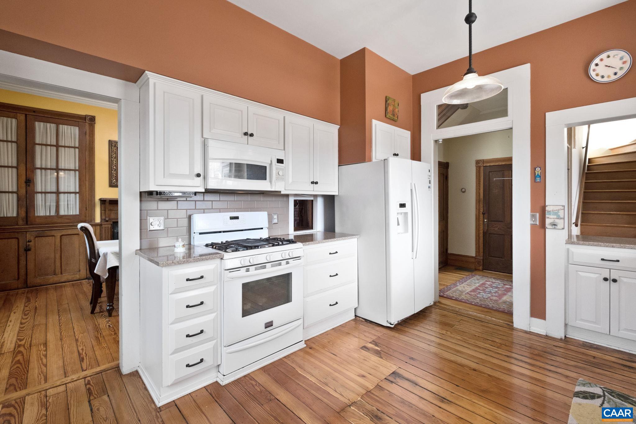 428 Maple Avenue Waynesboro, VA 22980 - Photo 15 of 69 a kitchen with stainless steel appliances white cabinets and wooden floors