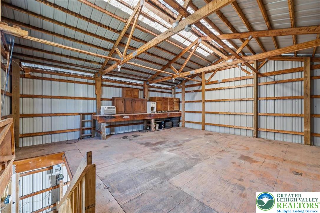 3453 Main Street Slatington, PA 18080 - Photo 23 of 30 A spacious barn interior with an exposed beam ceiling and ample workshop space.