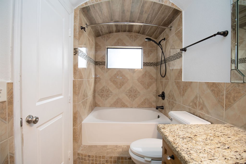 5201 Chapman Street Houston, TX 77009 - Photo 15 of 30 a bathroom with a toilet bathtub and shower