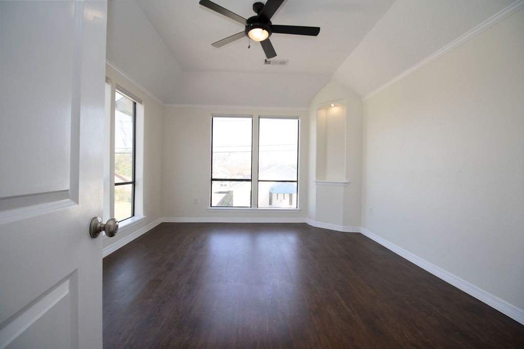 5201 Chapman Street Houston, TX 77009 - Photo 23 of 30 an empty room with wooden floor fan and windows