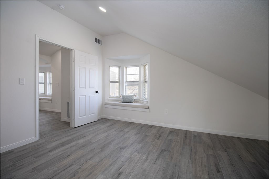 5201 Chapman Street Houston, TX 77009 - Photo 28 of 30 an empty room with wooden floor and windows