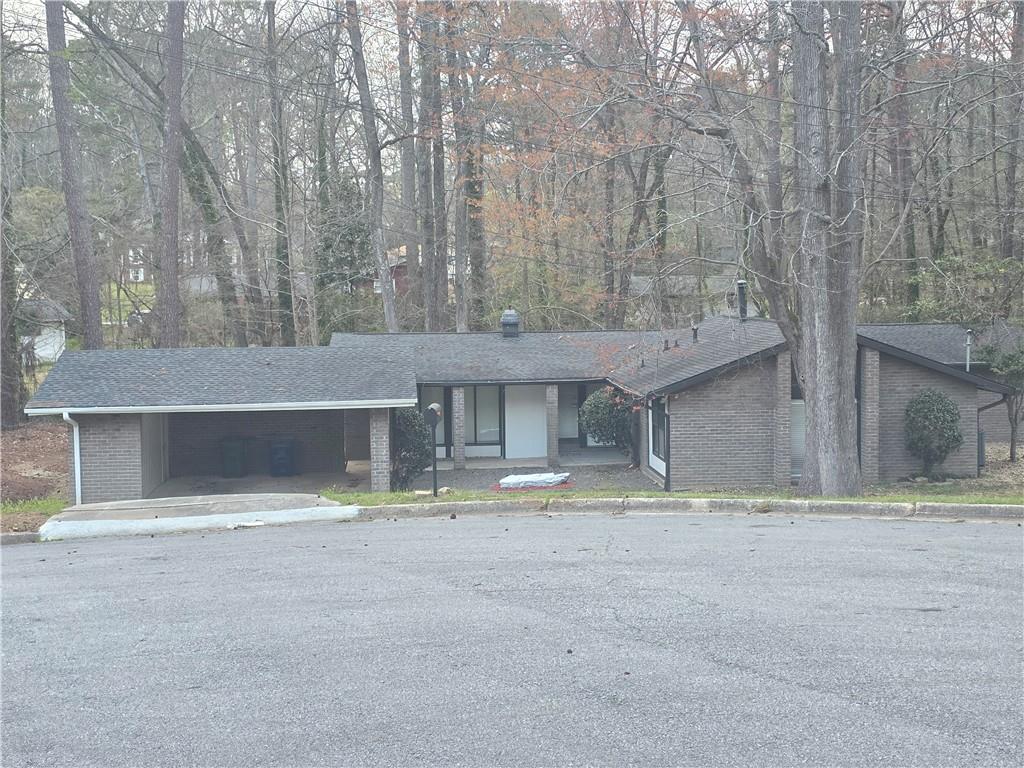 4055 Kelden Court Southwest Atlanta, GA 30349 - Photo 2 of 10 a front view of a house with a yard and garage