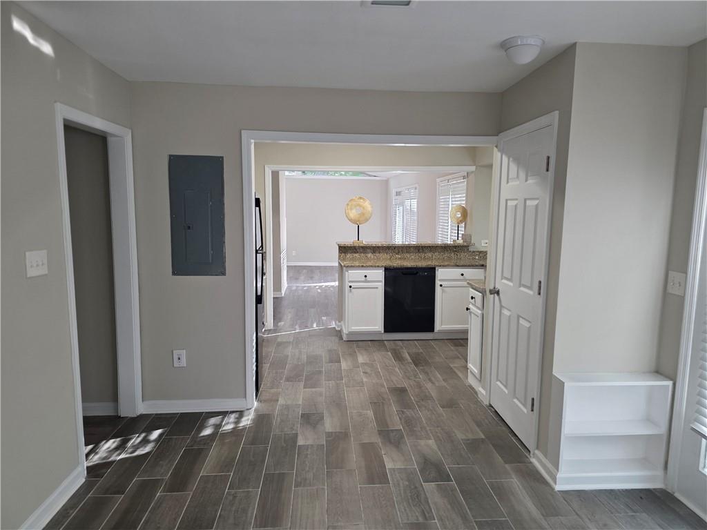 4055 Kelden Court Southwest Atlanta, GA 30349 - Photo 5 of 10 a view of a hallway with wooden floor and a fireplace