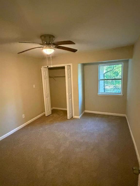 4055 Kelden Court Southwest Atlanta, GA 30349 - Photo 7 of 10 an empty room with windows and closet