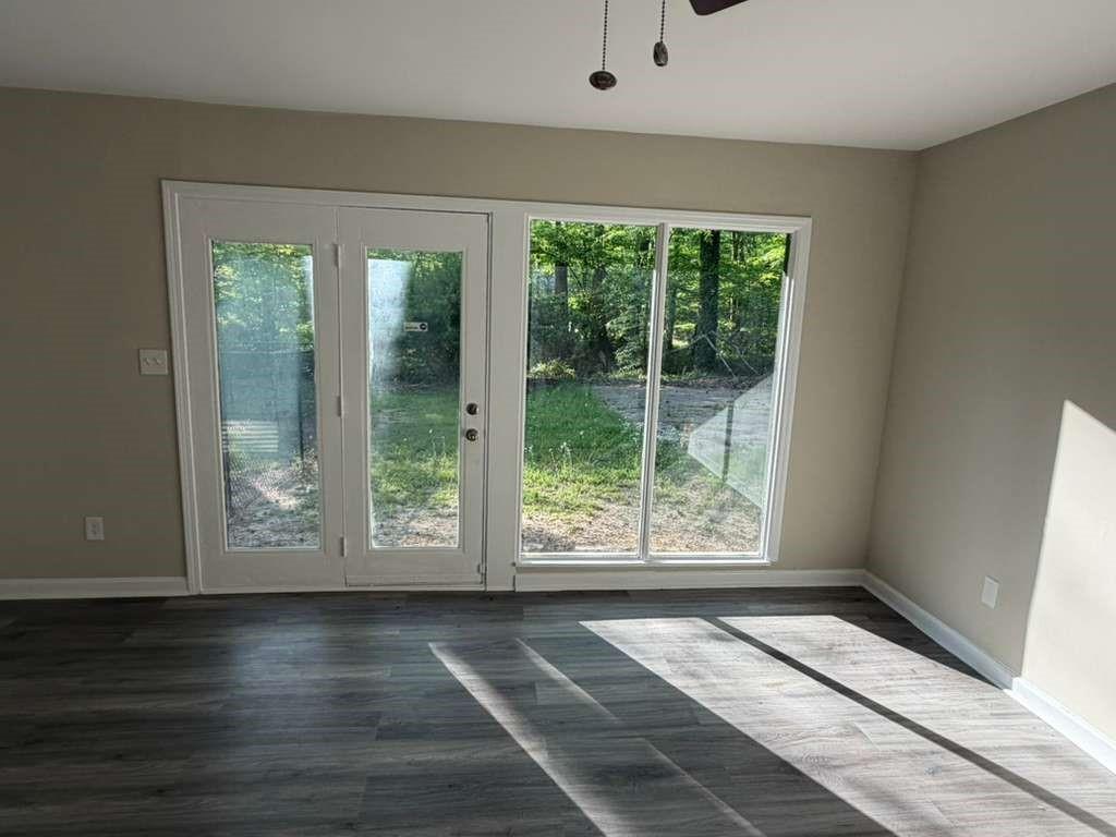 4055 Kelden Court Southwest Atlanta, GA 30349 - Photo 9 of 10 a view of an empty room with wooden floor and a window