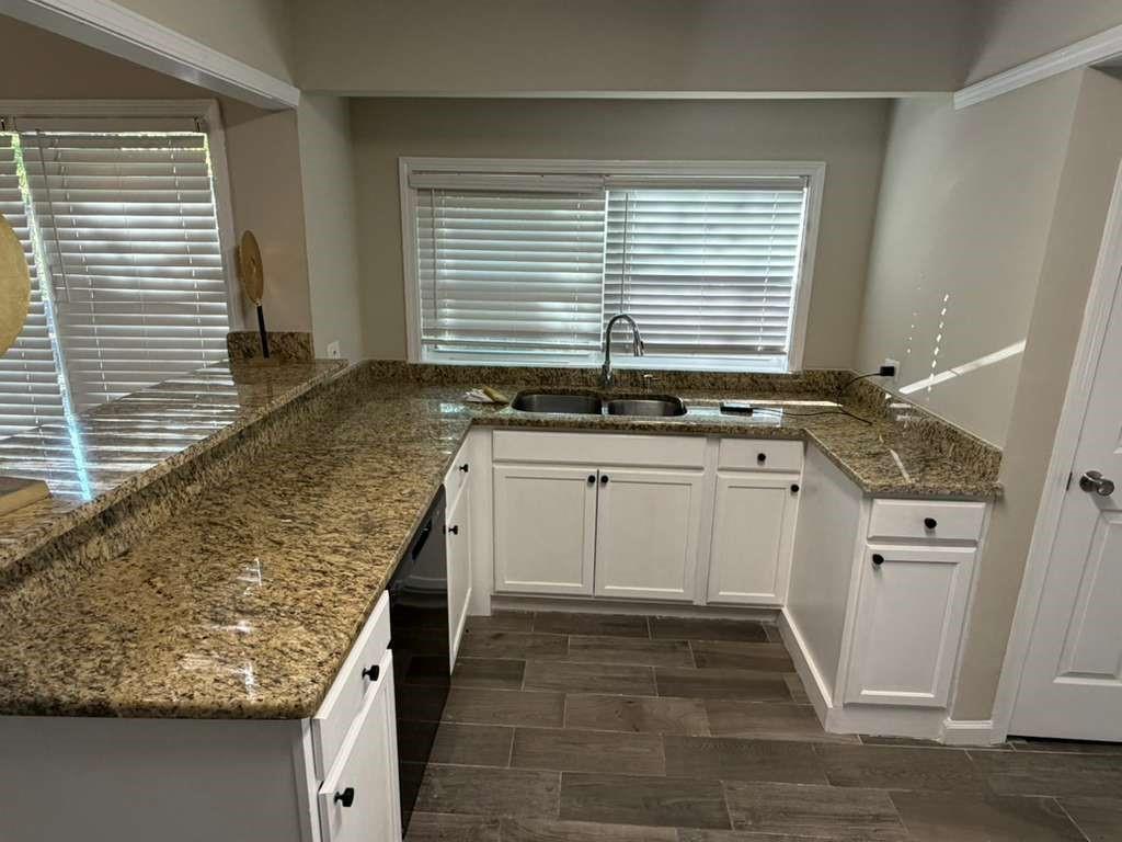 4055 Kelden Court Southwest Atlanta, GA 30349 - Photo 10 of 10 a kitchen with granite countertop sink and cabinets