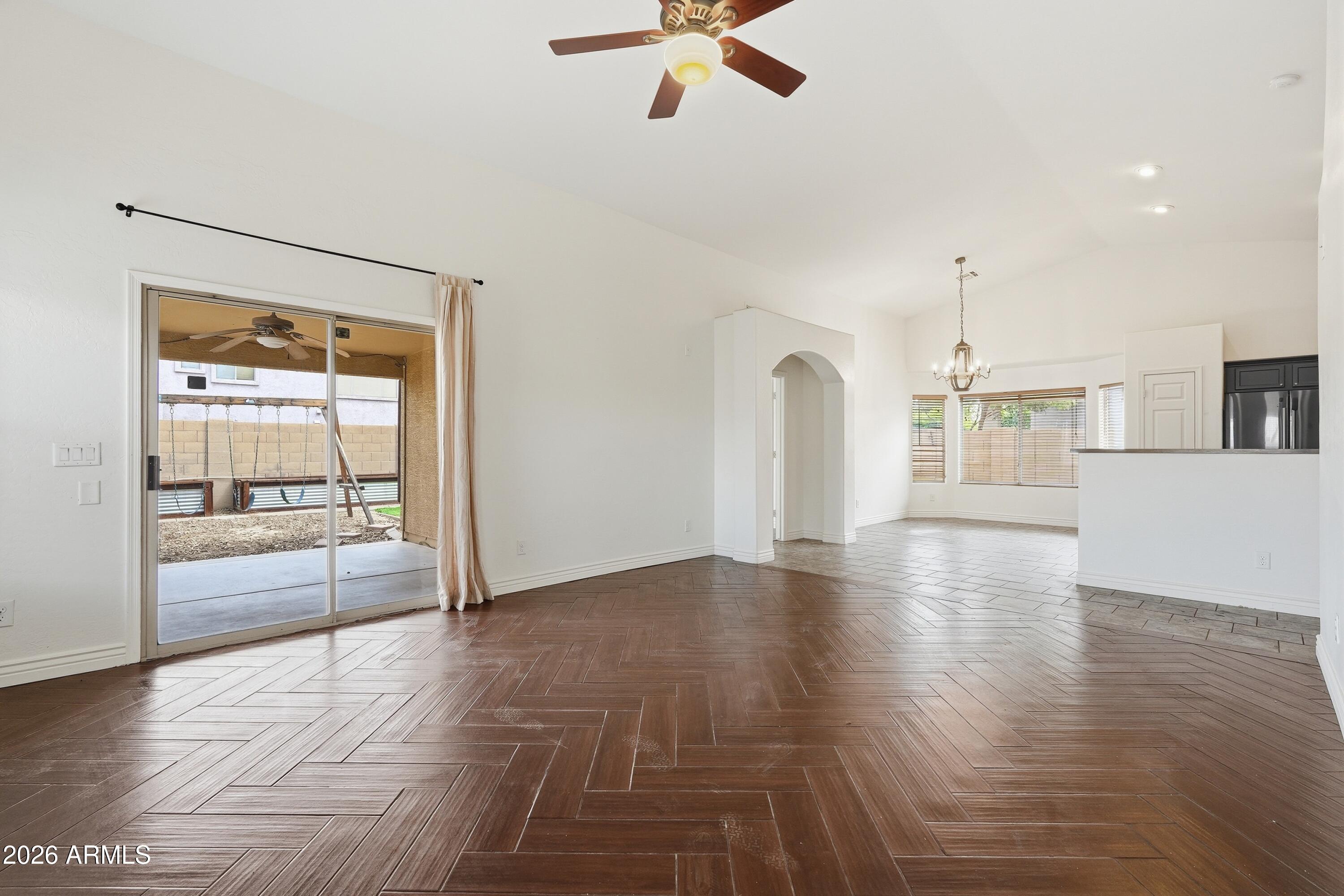 3242 East Bonanza Road Gilbert, AZ 85297 - Photo 9 of 36 a view of an empty room with window and wooden floor