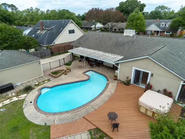an aerial view of a house with pool table and chairs