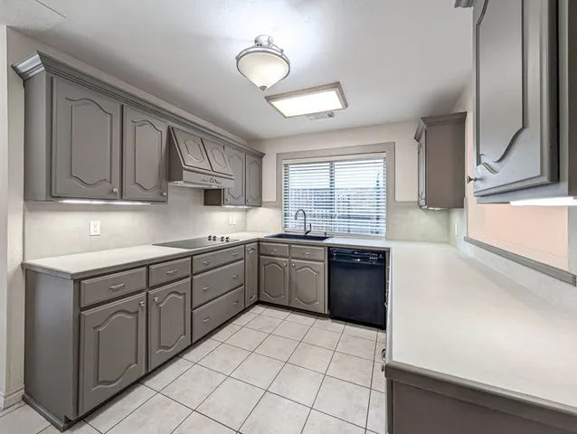 a kitchen with stainless steel appliances granite countertop a sink and cabinets