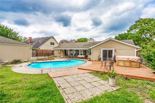 a front view of a house with swimming pool and porch