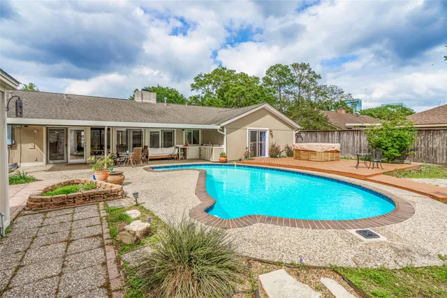 a house with swimming pool in front of it