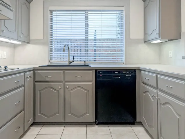 a kitchen with a sink and cabinets