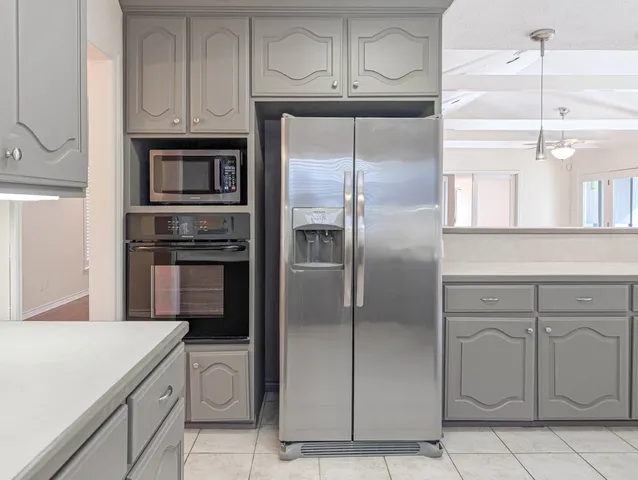 a kitchen with cabinets and stainless steel appliances