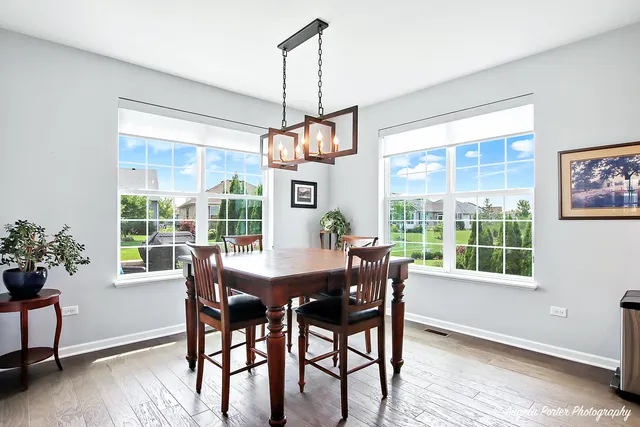 a view of a dining room with furniture window and wooden floor