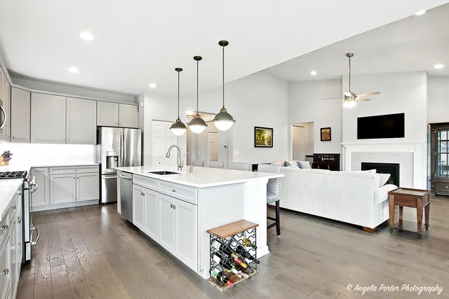 a open kitchen with white cabinets and stainless steel appliances