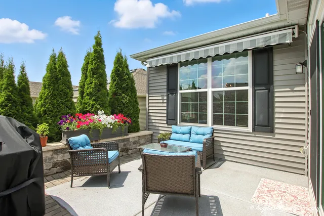 a view of a dining room with furniture and potted plants