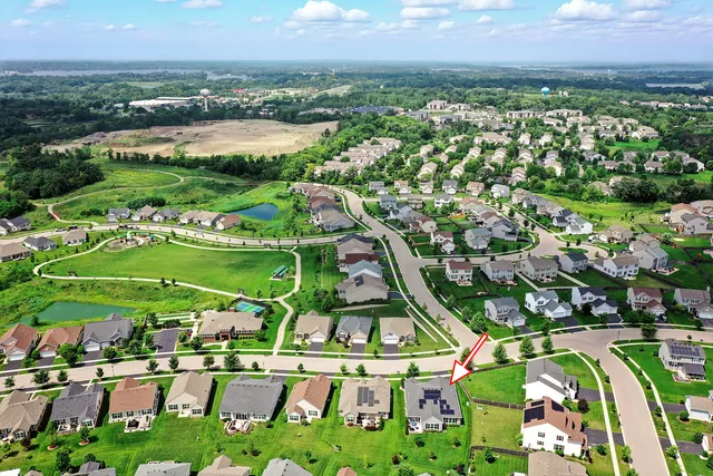 an aerial view of residential houses with outdoor space and street view