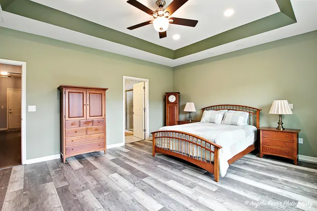 a bedroom with a bed and a ceiling fan