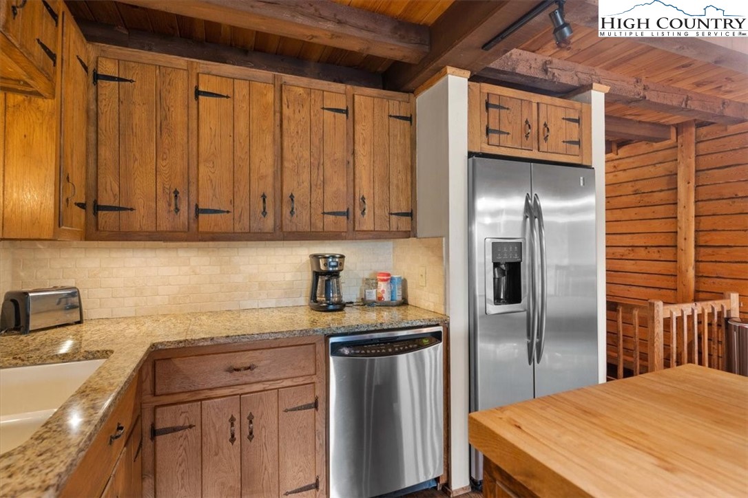 117 Chinkapin Ridge Road Seven Devils, NC 28604 - Photo 12 of 43 a kitchen with stainless steel appliances granite countertop a refrigerator a sink and dishwasher