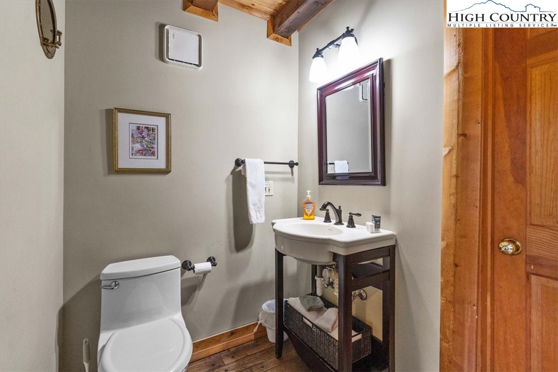 117 Chinkapin Ridge Road Seven Devils, NC 28604 - Photo 15 of 43 a bathroom with a toilet a sink and mirror